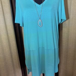 New with tags size large. By premise. Longer in back. Teal color. I have a one.